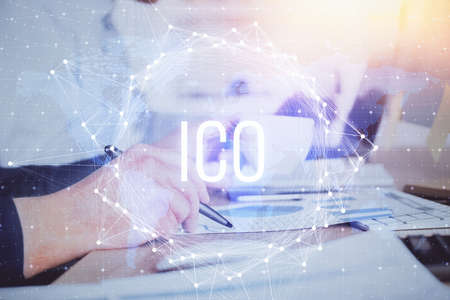 Mans hands working with notes background. Cryptocurrency and finance concept. Double exposure.