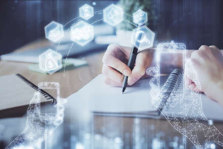 Tech theme hologram over womans hands taking notes background. Concept of hightech. Double exposure
