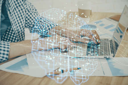 Man typing on keyboard background with brain hologram. Concept of big Data. Double exposure.の写真素材