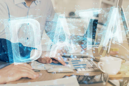 Double exposure of technology hologram with man working on computer background. Concept of big data.の写真素材
