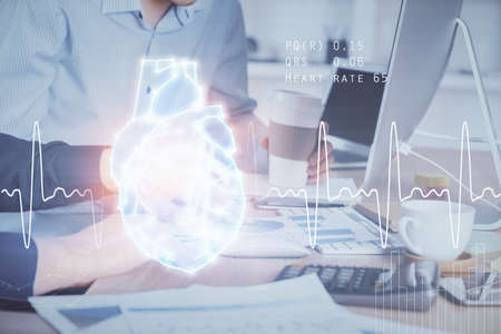Heart drawing with man working on computer on background. Medical concept. Double exposure.の写真素材
