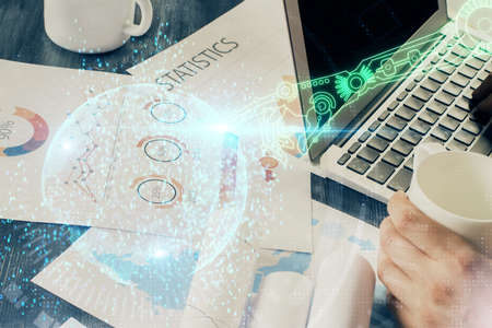Multi exposure of technology hologram with man working on computer background. Concept of big data.