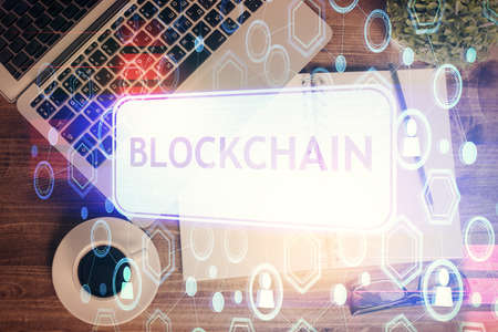 Blockchain theme hologram drawings over computer on the desktop background. Top view. Double exposure.の写真素材