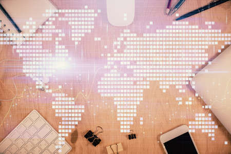 Double exposure of business theme hologram over desktop with phone. Top view. Mobile international...