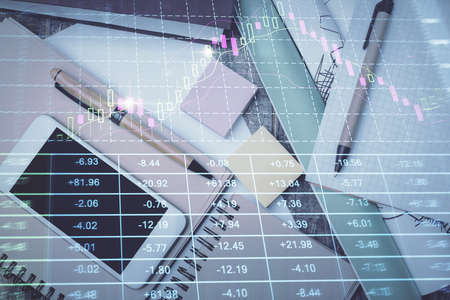 Multi exposure of forex graph hologram over desktop with phone. Top view. Mobile trade platform...