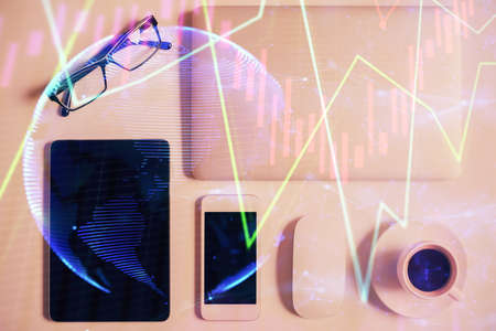 Multi exposure of financial chart hologram over desktop with phone. Top view. Mobile trade platform concept.の写真素材