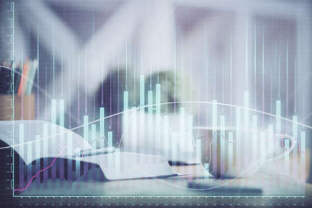 Multi exposure of forex graph drawing and desktop with coffee and items on table background. Concept...
