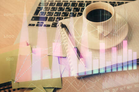 Double exposure of forex chart drawing and desktop with coffee and items on table background. Concept of financial market tradingの写真素材