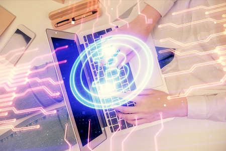 Double exposure of woman hands working on computer and blockchain theme hologram drawing. Top View....