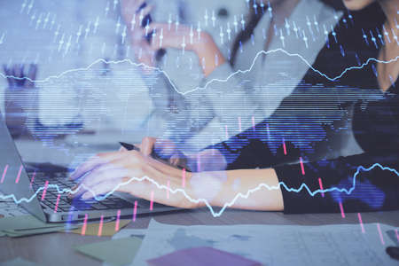 Multi exposure of woman hands typing on computer and financial graph hologram drawing. Stock market analysis concept.の写真素材