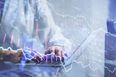 Double exposure of woman hands typing on computer and forex chart hologram drawing. Stock market...