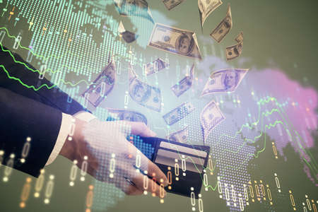 Multi exposure of financial graph drawing hologram and USA dollars bills and man hands. Analysis concept.の写真素材
