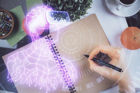 AR hologram over hands taking notes background. Concept of augmented reality. Double exposure