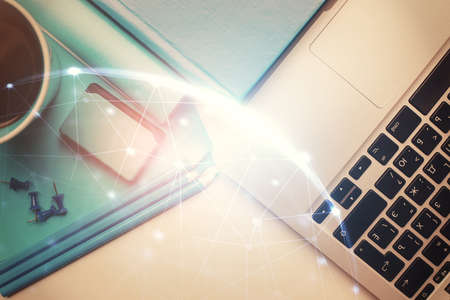 Social network hologram drawings over computer on the desktop background. Top view. Multi exposure. Concept of people connection.の写真素材