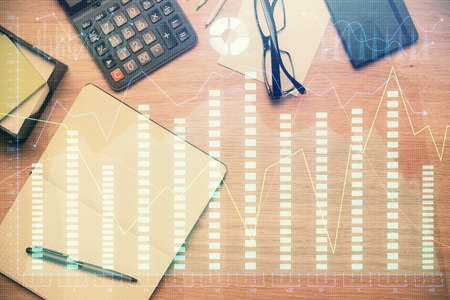 Double exposure of forex graph drawing and work table top veiw. Concept of financial analysis.