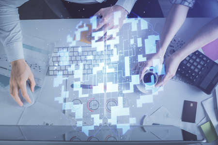 Double exposure of man and woman working together and data theme hologram drawing. Computer...