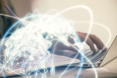 Multi exposure of woman hands typing on computer and business theme hologram drawing. Success concept.の写真素材