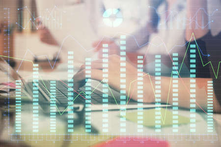 Multi exposure of woman hands typing on computer and financial graph hologram drawing. Stock market...