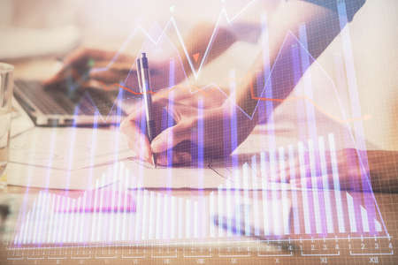 Multi exposure of woman hands typing on computer and financial chart hologram drawing. Stock market...
