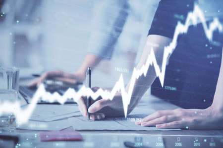 Multi exposure of woman hands typing on computer and financial chart hologram drawing. Stock market...