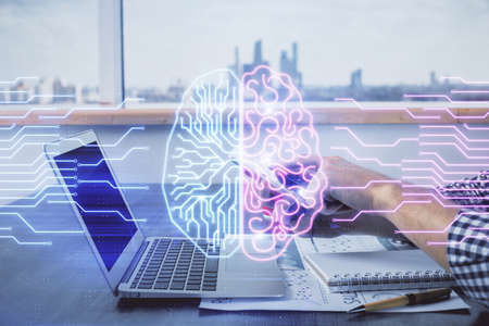 Double exposure of mans hand holding and using a digital device and brain hologram drawing. Data...