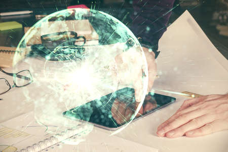 Double exposure of mans hands holding and using a phone and international business theme drawing.