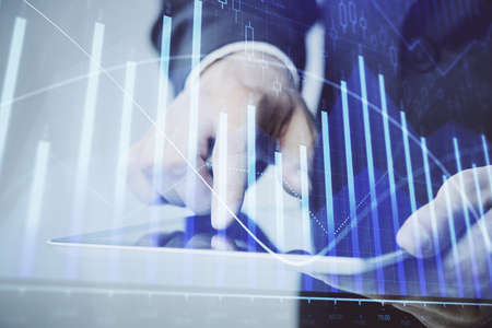 Multi exposure of mans hands holding and using a phone and financial chart drawing. Market analysis...