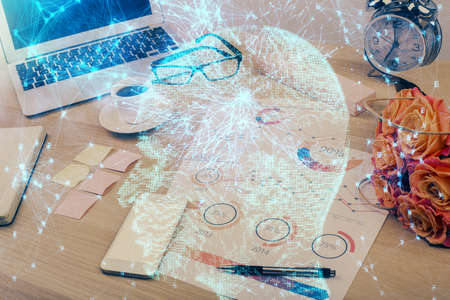 Double exposure of desktop with computer and brain drawing hologram. Artificial intelligence...