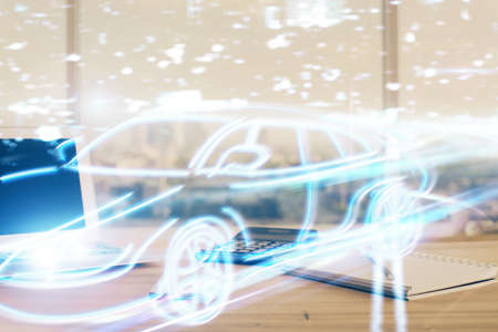 Desktop computer background in office with automobile hologram drawing. Multi exposure. Tech concept.の写真素材