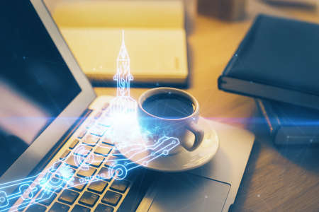 Desktop computer background in office and start up theme hologram drawing. Double exposure. Startup...