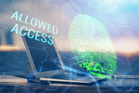 Computer on desktop in office with finger print drawing. Double exposure. Concept of business data...