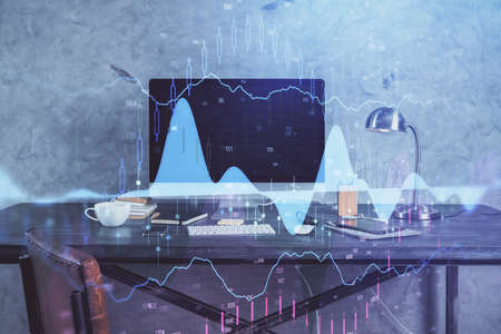 Double exposure of chart and financial info and work space with computer background. Concept of...