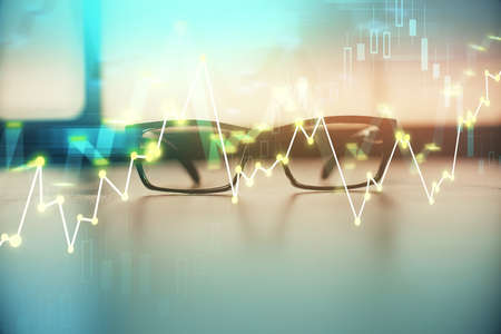 Financial graph hologram with glasses on the table background. Concept of business. Double exposure.