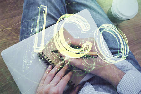 Mans hands working with notes background. Cryptocurrency and finance concept. Double exposure.