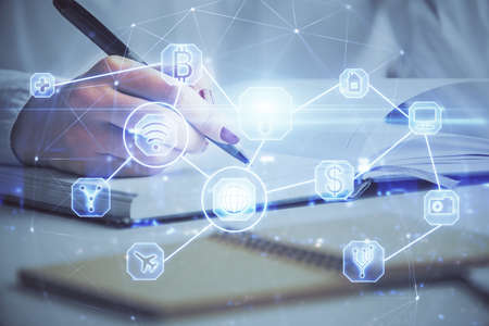 Social network theme hologram over hands taking notes background. Concept of global international people connect. Double exposureの写真素材