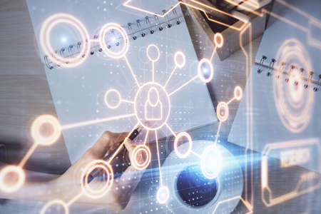 Social network theme hologram over hands taking notes background. Concept of global international people connect. Double exposureの写真素材