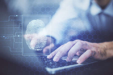 Fingerprint hologram with businessman working on computer on background. Security concept. Double...
