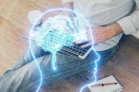Businessman with computer background with brain theme hologram. Concept of brainstorm. Multi...