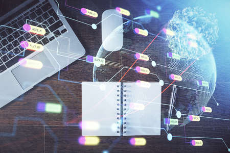 Double exposure of map hologram drawing over study table background with computer. Concept of international network. Top view.の写真素材
