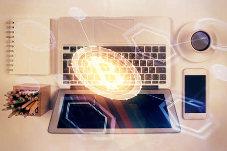 Blockchain theme hologram drawings over computer on the desktop background. Top view. Double...