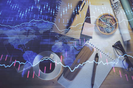 Double exposure of forex graph drawing and work table top veiw. Concept of financial analysis.
