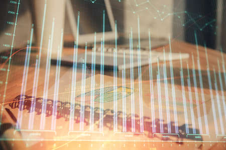 Double exposure of financial graph drawings and desk with open notebook background. Concept of forex marketの写真素材