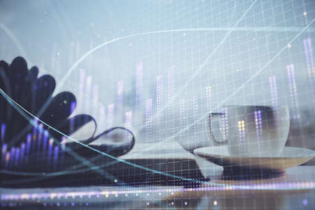 Double exposure of financial chart drawing and desktop with coffee and items on table background....