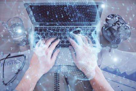 Double exposure of mans hands typing over computer keyboard and brain hologram drawing. Top view. Ai...