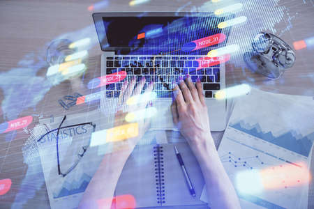 Double exposure of woman hands working on computer and data theme hologram drawing. Top View....