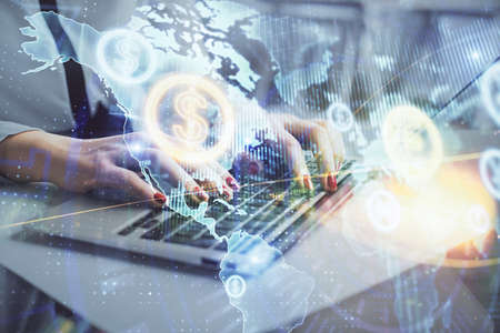 Multi exposure of woman hands typing on computer and financial graph hologram drawing. Stock market...