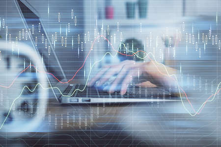Double exposure of woman hands typing on computer and forex chart hologram drawing. Stock market...