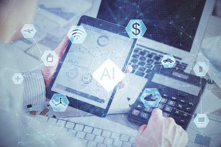 Double exposure of mans hand holding and using a digital device and data theme hologram drawing....