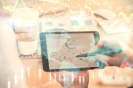 Double exposure of mans hands holding and using a phone and financial chart drawing. Market analysis...