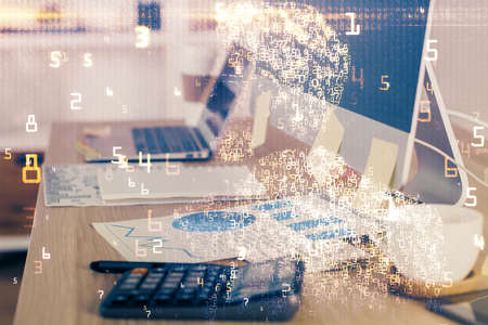 Computer on desktop in office with technology theme hologram. Multi exposure. Tech concept.の写真素材